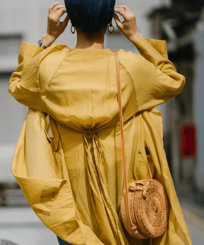 lady wearing straw bag on street